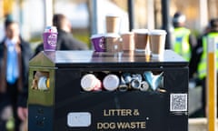 Compostable and recyclable takeaway coffee cups on top of overflowing litter bin in Glasgow, Scotland.