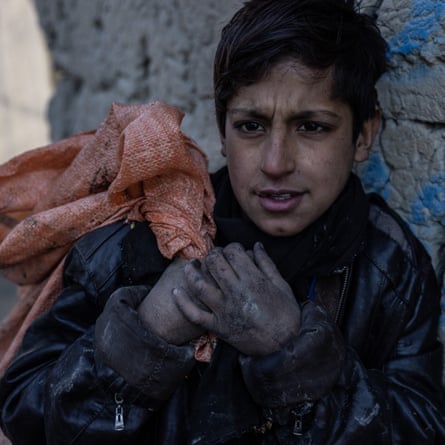 Noor Agha, 10, collects rubbish in Kabul to help his family pay for food. Child labour has risen since the Taliban takeover.