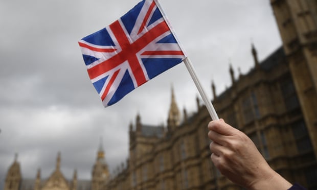 A pro-Brexit supporter holds a union jack near parliament.