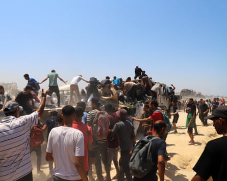 Palestinians rush towards aid trucks
