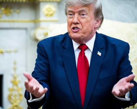 trump, a man in a blue suit and red tie, speaks in office with hands gestured