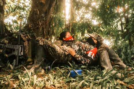 Two ELN members rest on the forest floor