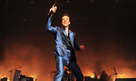 Brandon Flowers, frontman of band the Killers, gestures to the crowd during a performance.