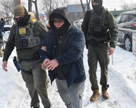 US Customs and Border Protection agents arrest a man after not providing documents proving he's a US citizen while patrolling a neighborhood in Minneapolis, Minnesota, on 11 January.