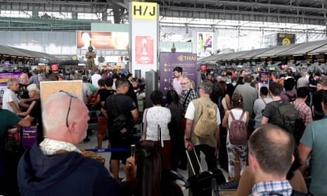 Stranded passengers wait at the check-in area at the Suvarnabhumi International Airport in Bangkok