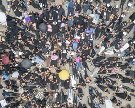 An aerial shot of scores of people lying on the ground