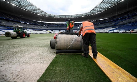Workers install a new pitch at Stade de France this week. The job was finished at 1am on Friday.