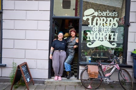 Nicole Egan and Cheryl Good stand in doorway of Lords of the North barbers in Warrington.