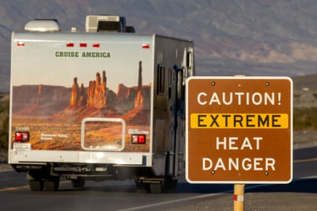 An RV passes a sign warning of extreme heat danger in Death Valley national park on 15 July 2023 near Furnace Creek, California.