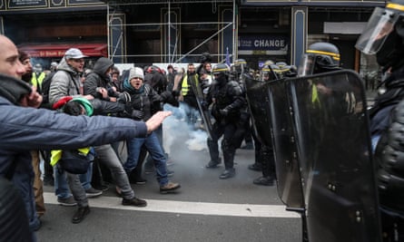 Protesters clash with riot police forces near the Opera Garnier in Paris.