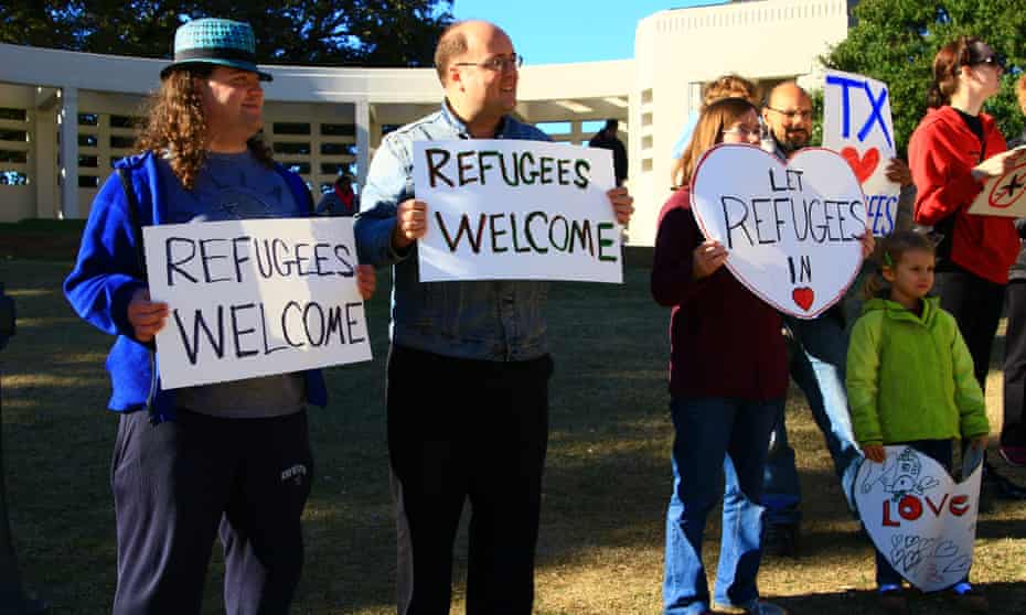 Human rights activists hold placards welcoming refugees to Dallas, and all of Texas, on 21 November.