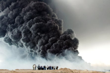 In Iraq, a small group watches a massive plume of black smoke from a burning oil pipeline.