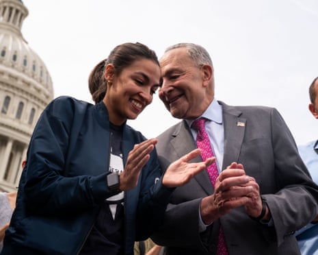 Smiling woman with hands open as if about to clap and man standing nearby with his hands folded