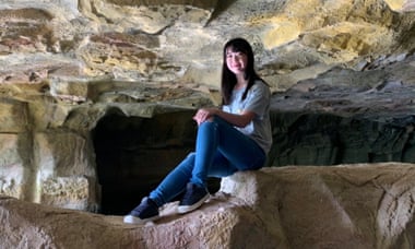 Nina Hong sitting in a rock crevice