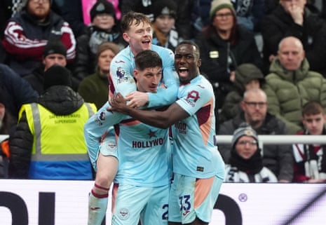 rentford's Vitaly Janelt (centre) celebrates with team-mates Keane Lewis-Potter (left) and Michael Kayode after scoring their side's equaliser at Newcastle.