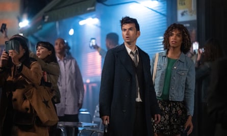 The Doctor and Rose standing in a night-time street.