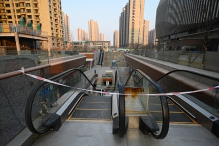 A blocked off escalator is seen at a partially operating Evergrande commercial complex in Beijing.