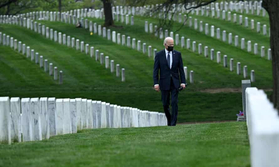 US President Joe Biden walks through Arlington National cemetary to honor fallen veterans of the Afghanistan conflict in Arlington, Virginia on 14 April 2021.