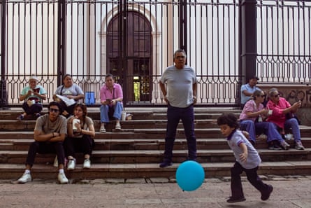 people on steps in front of a fence