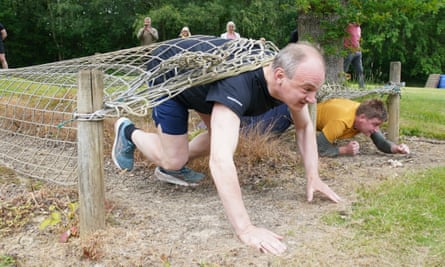 Davey crawling under a net on an obstacle course