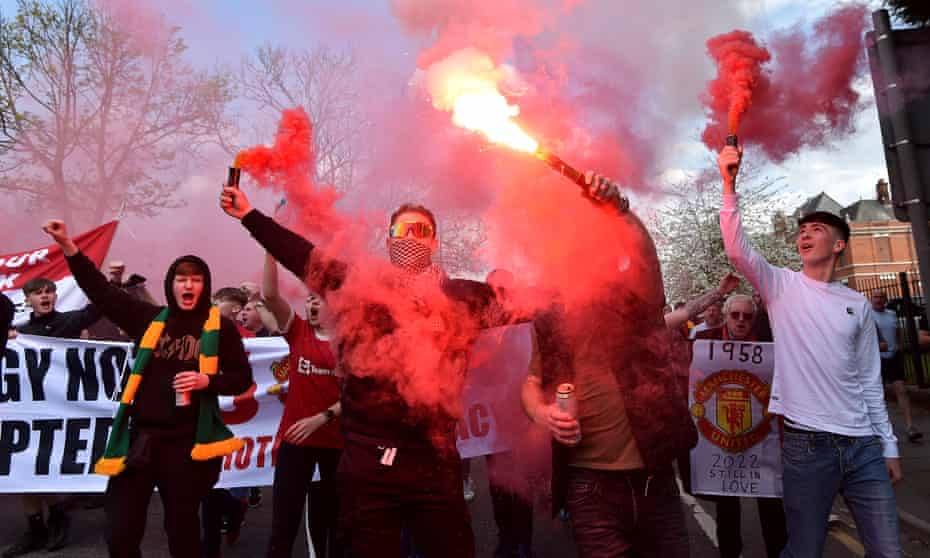 Manchester United fans set off flares and smoke bombs on the way to the ground