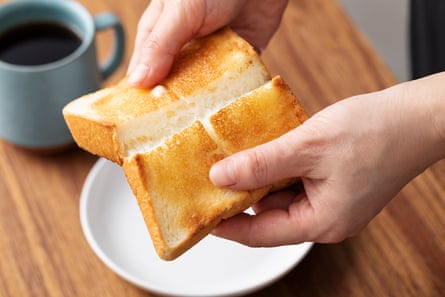 hands break a piece of toast