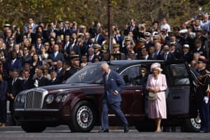Charles and Camilla step out of a car with crowds behind them