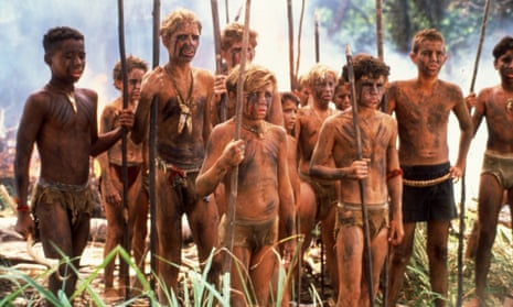 Half-naked boys holding long sticks in a scene from the 1990 film, Lord of the Flies