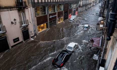 ‘Heatwaves, floods and droughts we see in the news make catastrophe easier to imagine.’ A street becomes a river in the floods in Sicily, Italy, this month.