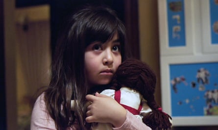 Young girl cradles a doll