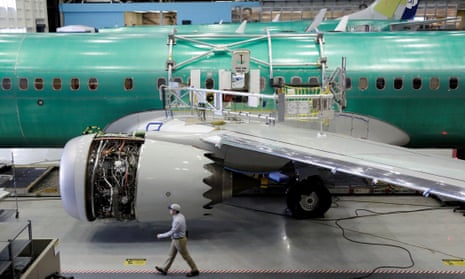 A worker walks past a Boeing 737 Max 9 under construction at the aircraft maker’s production facility in Renton, Washington, in February 2017.