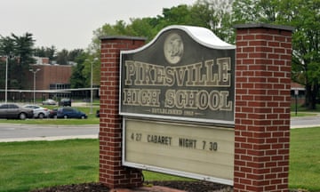 This undated photo shows the The Pikesville High School sign on the school property. Baltimore County Police Chief Robert McCullough and other local officials speak at a news conference in Towson, Maryland, on Thursday, April 25, 2024. The officials discussed the arrest of a high school athletic director on charges ​that he used artificial intelligence to impersonate a principal on an audio recording that included racist and antisemitic comments. (Lloyd Fox/The Baltimore Sun via AP)