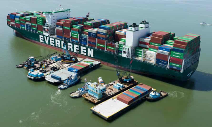 In this photo taken on April 11 2022 a tugboat pushes a barge full of containers away from the Ever Forward container ship in Pasadena, Maryland