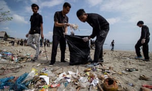 Students cleaning up plastic waste that pollutes the beach in Ujong Blang village, Indonesia.