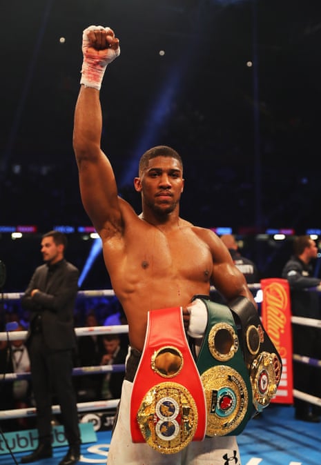 Anthony Joshua celebrates his victory and shows off his IBF, WBA &amp; IBO Heavyweight Championship belts, which he retained.