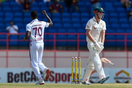West Indies’ Shamar Joseph (left) celebrates the dismissal of Cameron Green (right) of Australia.