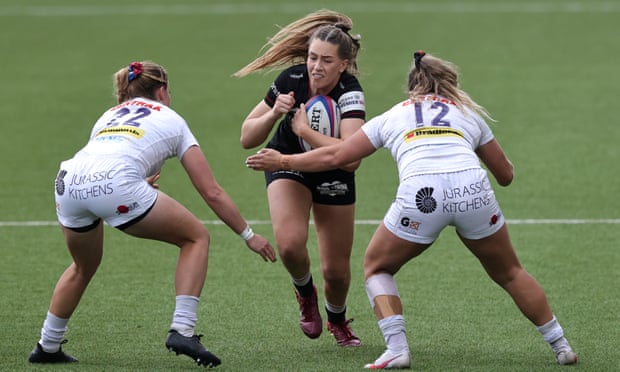 Holly Aitchison tries to slip between two Exeter players