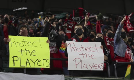 Portland Thorns fans hold signs in solidarity with players following allegations of abuse in 2021