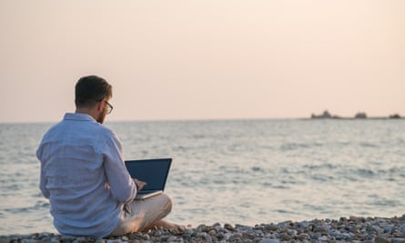 Man on beach with laptop