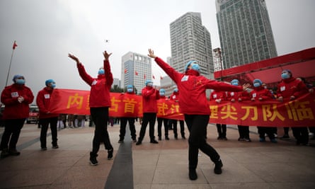 Medical workers celebrate the shutting down of a temporary hospital for coronavirus patients in Wuhan.