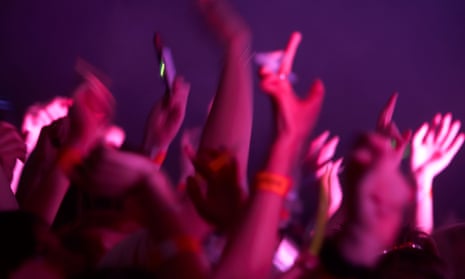 Arms and hands waving in the air at a music event