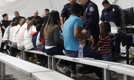 Migrants who are applying for asylum in the US go through a processing area in a new tent courtroom at a facility in Laredo, Texas. 