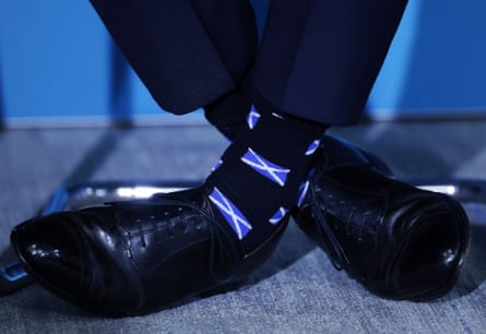Farage, wearing saltire flag socks, at a press conference in London on 13 April.