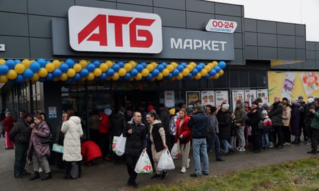 People wait to enter the ATB store in Kherson