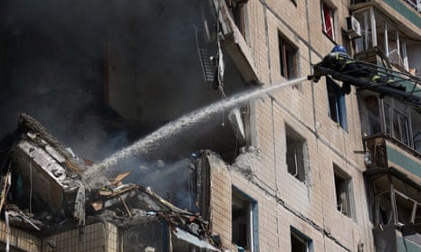 A firefighter works at a site of a block of flats heavily damaged by a Russian missile strike in Kryvyi Rih.