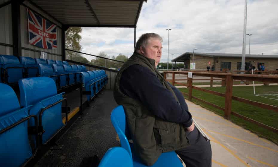 John Stancombe, here at Sandbach United, arranges with the clubs he visits for a volunteer to describe the stadium to him and for a commentator to talk him through the match.