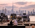 UAE-DAILY LIFE-TOURISMA couple sits at Dubai's Creek Harbour, with the Burj Khalifa visible in the background, on April 3, 2026. (Photo by FADEL SENNA / AFP via Getty Images)