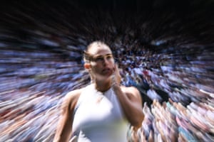 Aryna Sabalenka on court at Wimbledon with the crowd blurred