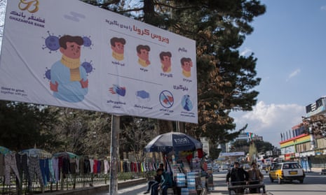 Signs warns of the risks of the coronavirus in Kabul