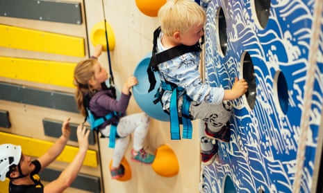 Children on the climbing wall at Adrenaline Indoors, Adventure Parc Snowdonia